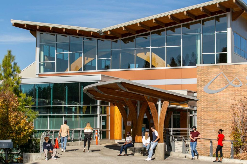 The front entrance of College of the Rockies with students in the foreground.