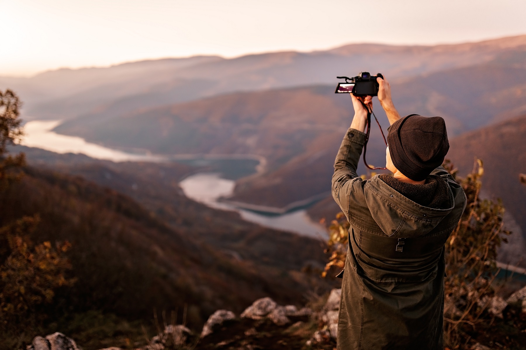 Young photographer making photographs of mountain range