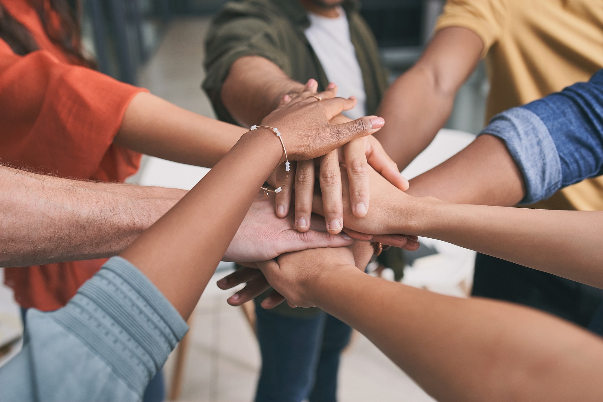 Shot of a unrecognizable team of business people stacking their hands in motivation