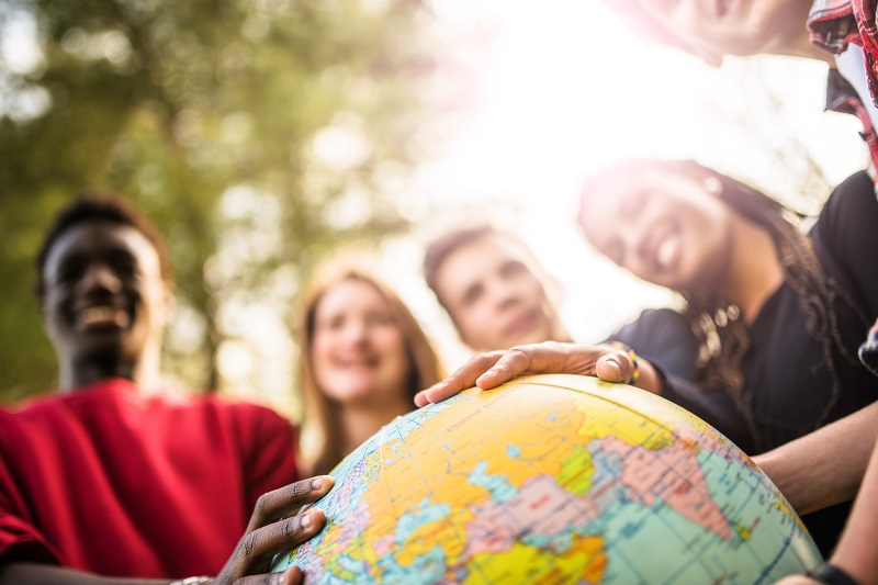 teenagers college student smiling with globe